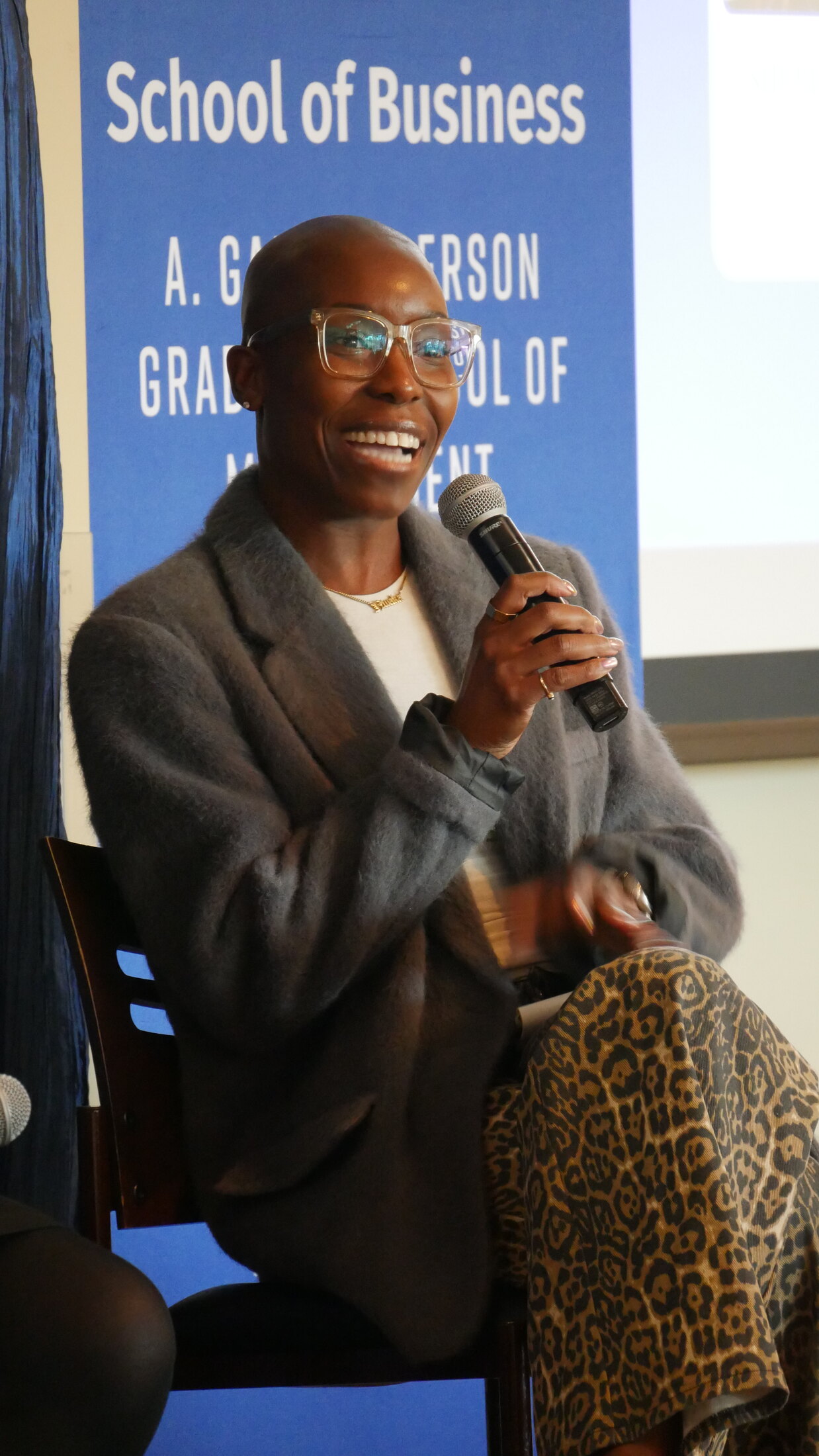 Nwaka Onwusa speaking into a microphone during a panel conversation