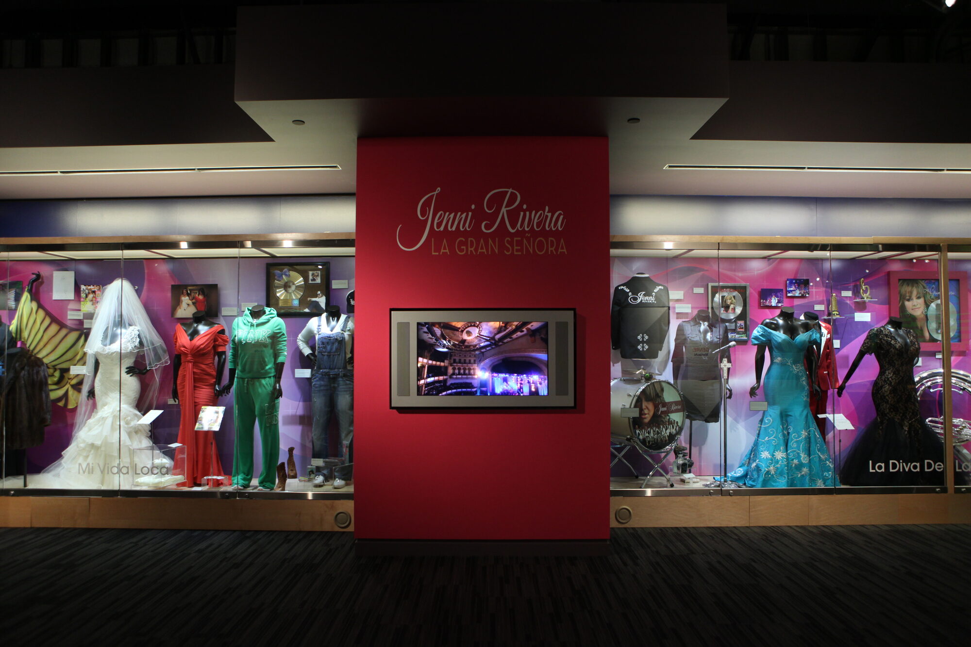 La Gran Se&ntilde;ora gallery featuring Jenni Rivera&rsquo;s stage gowns, everyday clothing, and video wall