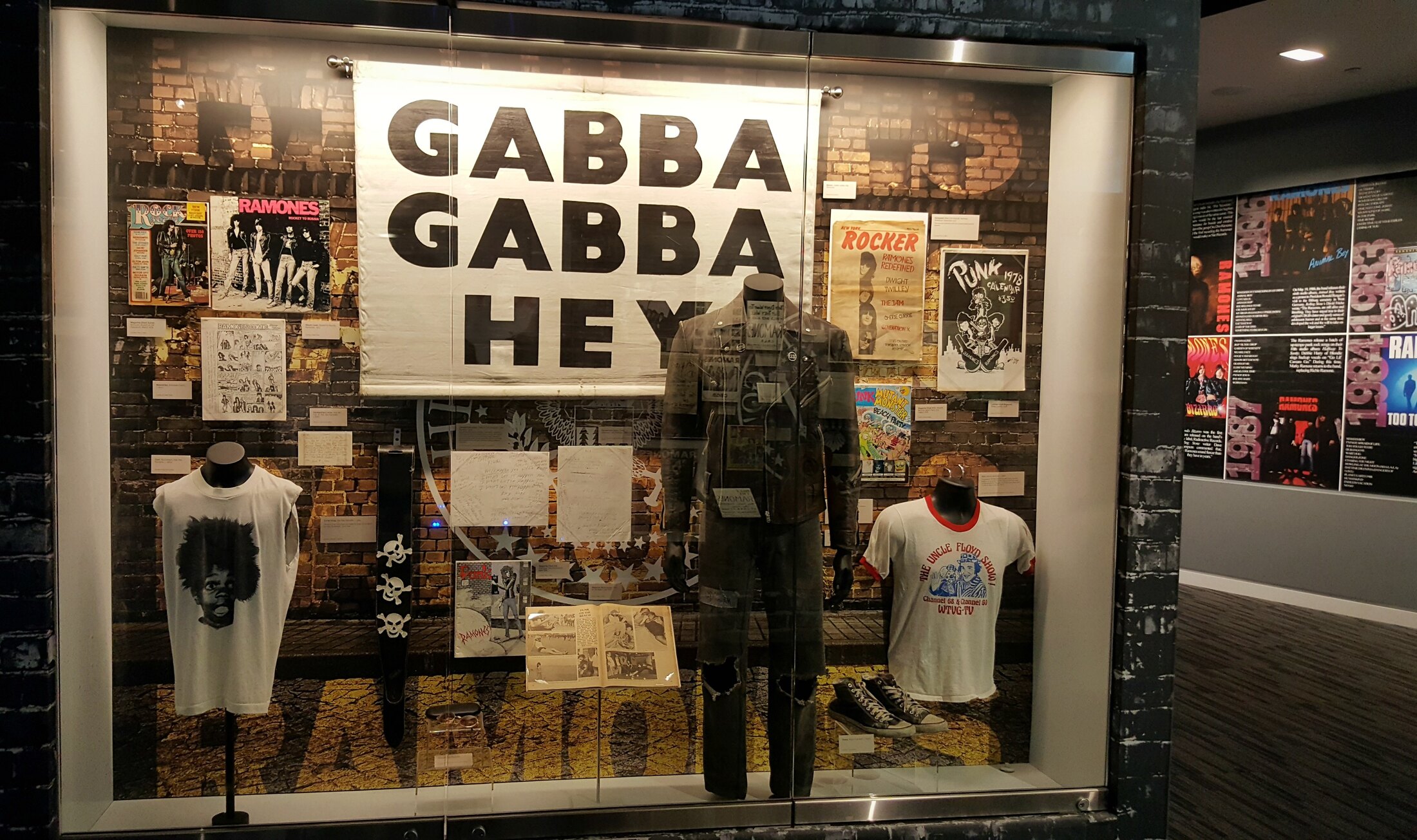 Ramones exhibition display featuring the Gabba Gabba Hey banner and band artifacts