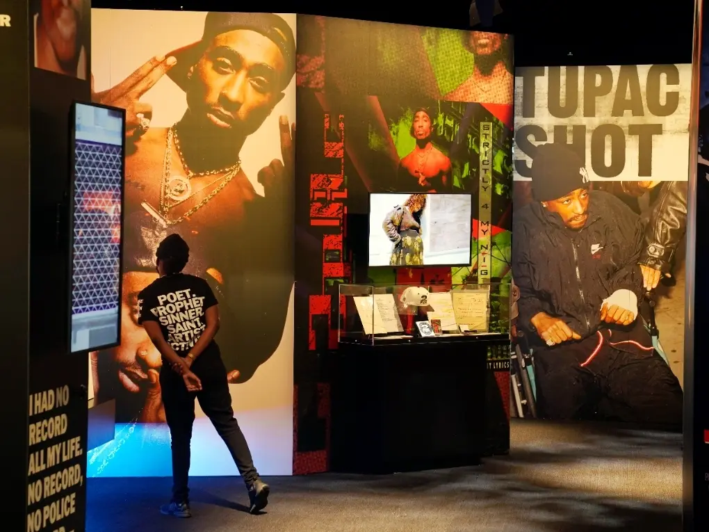 Visitor exploring the Tupac history and artifact installation